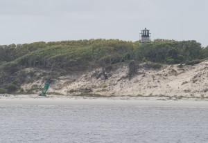 Green marker stuck in sand below abandoned light house. South side of St Andrew Sound