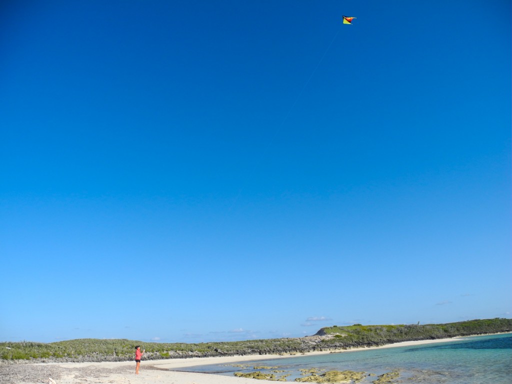 Flying a kite on a deserted beach